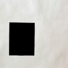 A striking minimalist black square on a textured white wall offers creative copyspace.